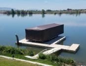 Pontoon boat on a floating dock with the touchless boat cover