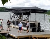 Pontoon boat on a floating dock with the touchless boat cover. Automatic boat cover