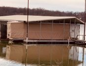 Pontoon boat on a floating dock with the touchless boat cover. Automatic boat cover
