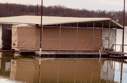 Pontoon boat on a floating dock with the touchless boat cover. Automatic boat cover