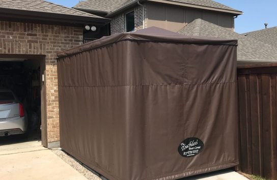 Brown Colored Automatic Golf Cart Cover outside of a house